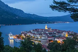 Elevated view over Korculas picturesque Stari Grad illuminated at dusk, Korcula