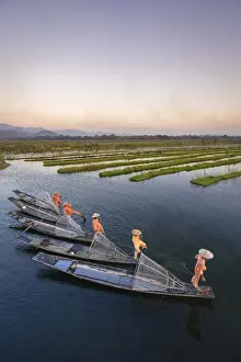 Intha Prints: Elevated view of five leg-rowing fishermen rowing on Lake Inle before sunset, Lake Inle