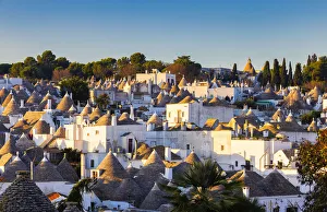 Itria Valley Prints: Elevated view of monumental trulli area at sunrise. Unesco World Heritage Site