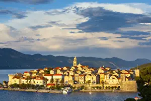 Elevated view over picturesque Korcula Town illuminated at sunset, Korcula, Dalmatia