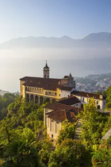 Borromean Gulf Prints: Elevated view over the picturesque Sanctuary of Madonna del Sasso illuminated at sunrise