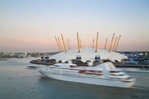 England, London, Ariel view of Cruise ship passing O2 Arena, (Millennium Dome)