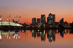 England, London, Newham, O2 Arena and Canary Wharf buildings reflecting in Royal Victoria Docks