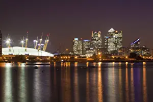 England, London, Newham, O2 Arena and Canary Wharf buildings reflecting in Royal Victoria