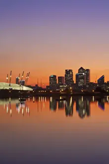 England, London, Newham, O2 Arena and Canary Wharf buildings reflecting in Royal Victoria Docks