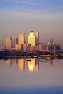 England, London, Newham, Royal Victoria Docks, Canary Wharf buildings at dawn