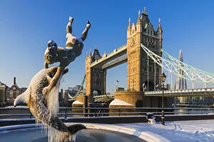 Images Dated 18th May 2018: England, London, Tower Hill, The Girl with a Dolphin and Tower Bridge in the Snow