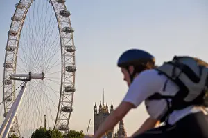 Bikes Prints: England, London, Westminster, Man cycling with The London Eye & The Houses of Parliament
