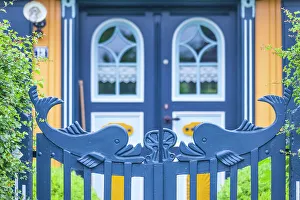 Entrance gate with whales at a beautiful, old thatched roof house in Born am Darss, Mecklenburg-West Pomerania, Baltic Sea, Northern Germany, Germany