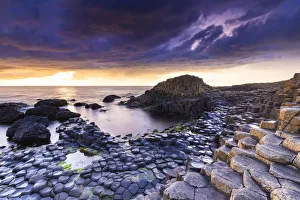An epic sunset at the Giants Causeway with its iconic basalt columns An epic sunset at the Giants Causeway with its iconic basalt columns