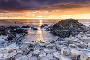 An epic sunset at the Giants Causeway with its iconic basalt columns