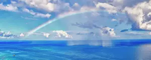 Cloud Prints: Ethereal sky with rainbow during a thunderstorm over the blue waters of Caribbean Sea