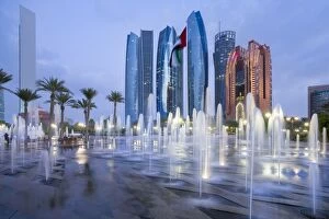 Images Dated 6th December 2016: Etihad Towers time lapse viewed over the fountains of the Emirates Palace Hotel, Abu Dhabi
