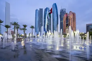 Fountains Prints: Etihad Towers time lapse viewed over the fountains of the Emirates Palace Hotel, Abu Dhabi