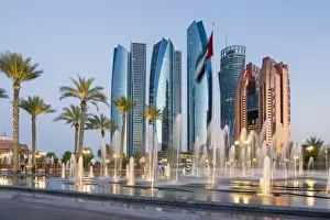 Comtemporary Prints: Etihad Towers time lapse viewed over the fountains of the Emirates Palace Hotel, Abu Dhabi