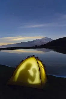Etna Prints: Etna erupting, is reflected in a lake at night on the Nebrodi muntains in the north of Sicily