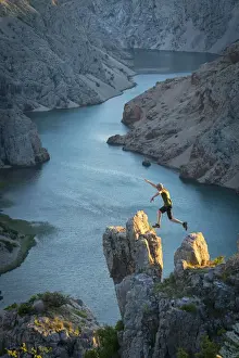 Jump Prints: Europe, Balkan, Croatia, man with hat jumping at Zrmanja canyon