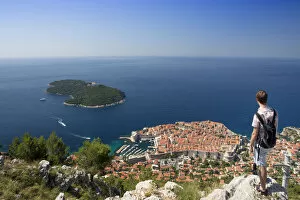 Images Dated 6th August 2014: Europe, Croatia, Dalmatia, Dubrovnik, a tourist looking out over the historic centre