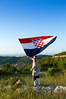 Images Dated 6th August 2014: Europe, Croatia, Dalmatia, Korcula Island, Blato, a local in traditional dress waving