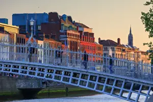 Europe; Dublin, Halfpenny bridge and Liffey river at sunset
