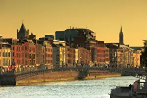 Europe; Dublin, Halfpenny bridge and Liffey river at sunset