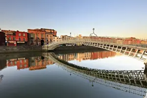 Europe; Dublin, Halfpenny bridge and Liffey river at sunset