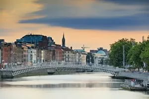 Images Dated 18th July 2017: Europe, Dublin, Ireland, Half Penny bridge at sunset reflecting in the Liffey river