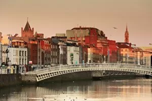 Images Dated 18th July 2017: Europe, Dublin, Ireland, Halfpenny bridge at sunrise with buildings reflecting in