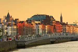 Europe, Dublin, Ireland, tourists crossing the famous Halfpenny bridge on the Liffey