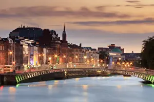Europe, Dublin, Ireland, tourists crossing the famous Halfpenny bridge on the Liffey