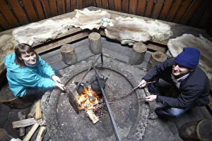 Images Dated 25th November 2013: Europe, Finland, Lapland, Salla, tourists cooking over a wooden fire in a typical