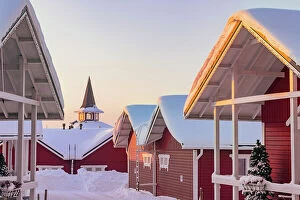 Snowfall Collection: Europe, Finland, red buildings at Santa Claus village in Rovaniemi