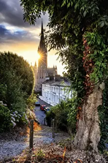 Europe, Ireland, Cork, Cobh Cathedral at colored houses at sunrise