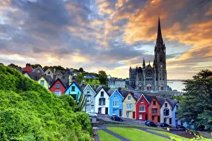 Europe, Ireland, Cork, Cobh Cathedral at colored houses at sunrise