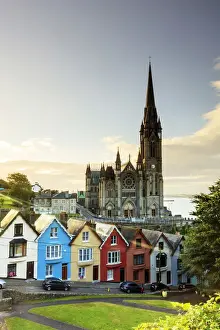 Europe, Ireland, Cork, Cobh Cathedral at colored houses at sunrise