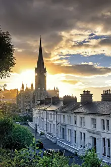 Europe, Ireland, Cork, Cobh Cathedral at colored houses at sunrise