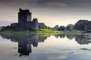 Europe, Ireland, Dunguaire castle at sunrise in Kinvara village reflecting in