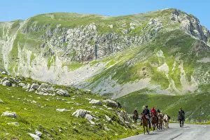 europe, Italy, the Abruzzi. Riders on a road in the National Park of Gran Sasso