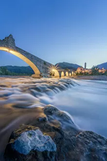 Waterfalls Collection: Europe, Italy, Emilia Romagna: Bobbio, falls on the Trebbia river and the medieval town at twilight