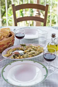 Table Prints: europe, Italy, Liguria, a lunch table in an agriturismo with home made ravioli and red wine