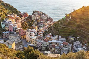 Images Dated 19th March 2020: Europe, Italy, Liguria. View over the Cinque Terre village Manarola at sunset