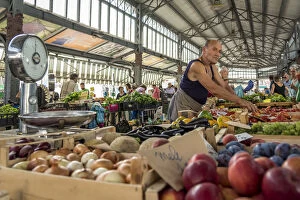 Europe, Italy, Piedmont. Fruit seller at the Porta Palazzo market in Turin