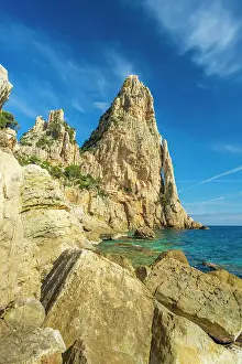Trekking Prints: Europe, Italy, Sardinia. On the rocky beach near to the caracteristic rock needle Pedra Longa
