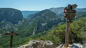 Europe, Italy, Sardinia. Signposts on the hiking trail to the archeological site of Tiscali village