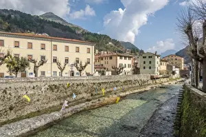 Versilia Prints: Europe, Italy, Seravezza a view of the town and the river with an art installation