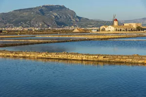Europe, Italy, Sicily. In the saline of Trapani looking towards Erice