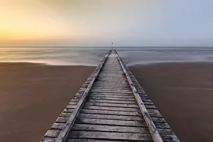 Europe, Italy, Veneto, Venice, Jesolo. A wooden pier on the beach towards adriatic sea