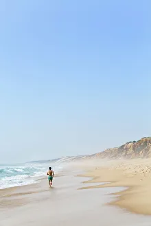 Images Dated 23rd September 2015: Europe, Portugal, Alentejo, Grandola, a man running along Praia da Gale beach near