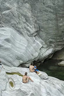Images Dated 13th May 2015: Europe, Switzerland, Ticino, Maggia Valley, two women in swim suits sitting on rocks