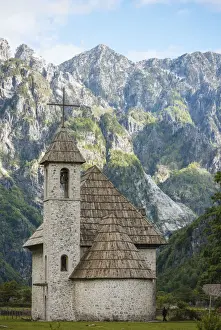 Albanian Prints: Exterior of Theth Village Church with The Accursed Mountains in background, Theth